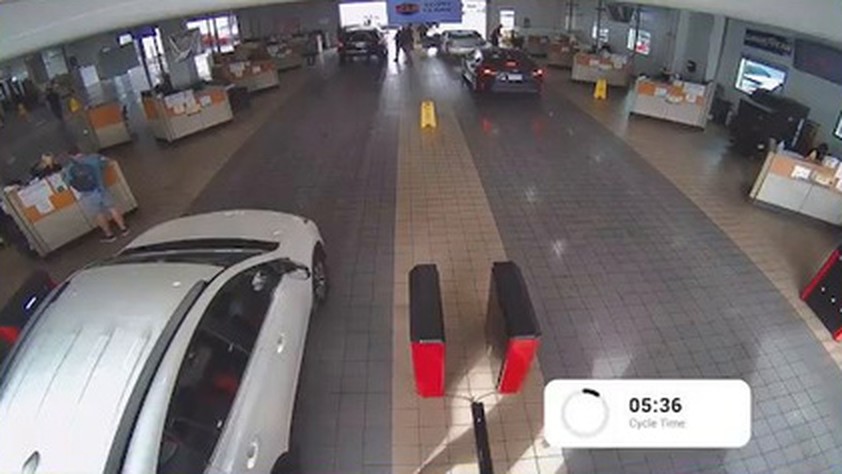 Service lane camera view showing vehicles and advisor activity