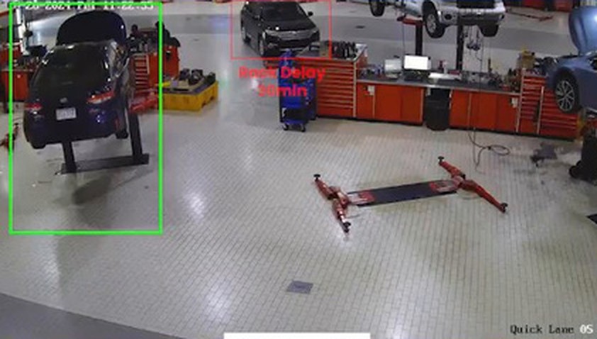 Service bay camera view detecting a vehicle on the rack and a bay delay